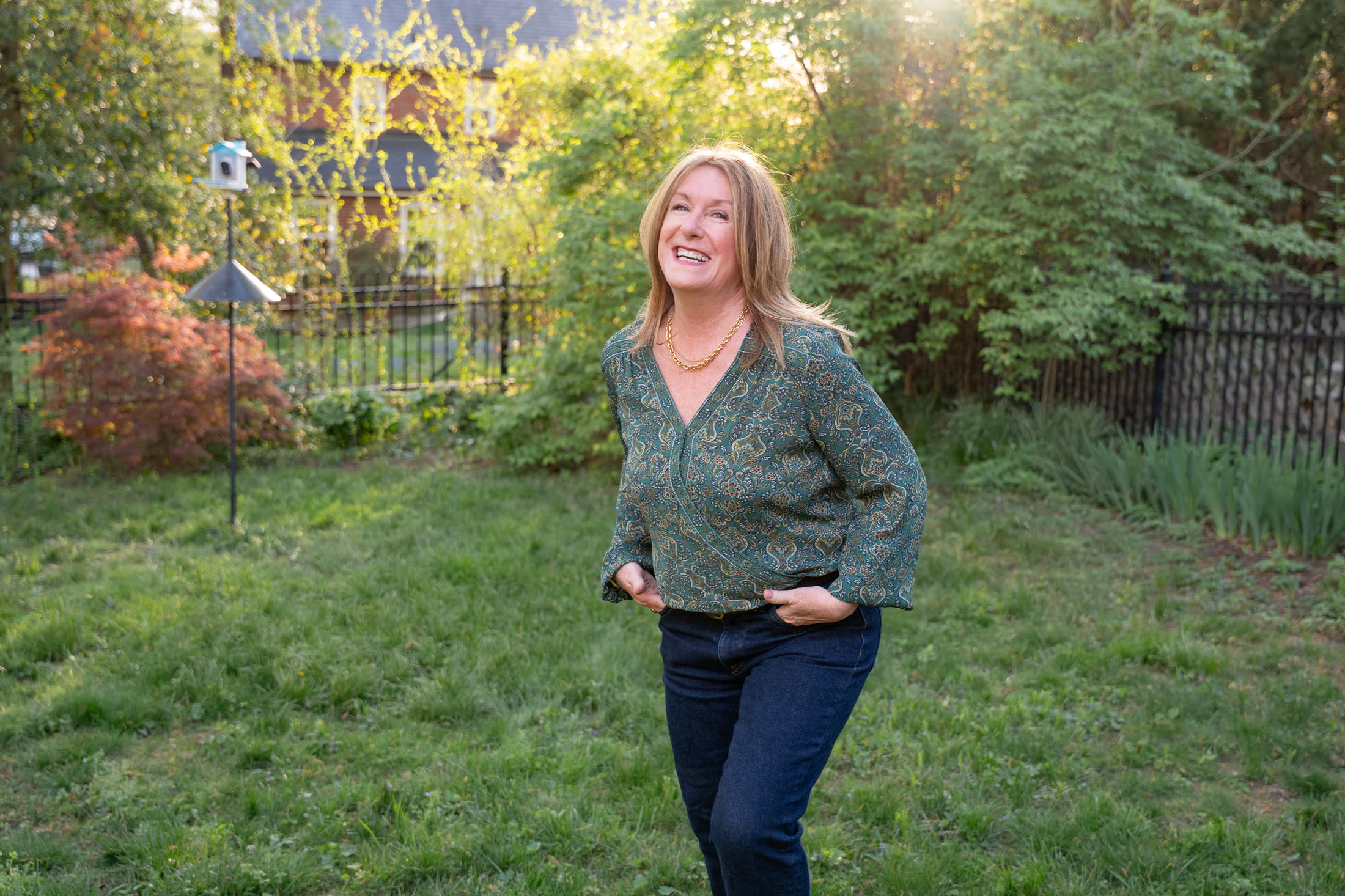 Carolyn Lorente standing in a green backyard setting.