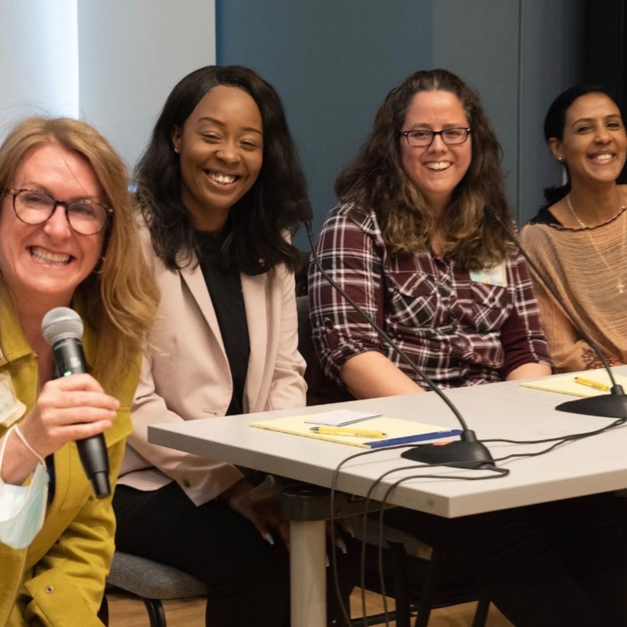 Carolyn Lorente speaking on a panel with other presenters.